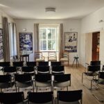 Das Bild zeigt den Seminarraum des Bonhoeffer-Hauses in Reihenbestuhlung, bereit für eine Veranstaltung oder ein Vortrag. The picture shows the seminar room of the Bonhoeffer House arranged with rows of chairs, prepared for a lecture or event.
